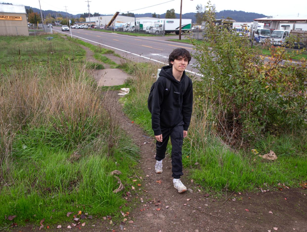 Deion Flemings makes his way up a makeshift path along South Bertelsen near 11th Ave. on Tuesday. The area is scheduled for a new sidewalk.