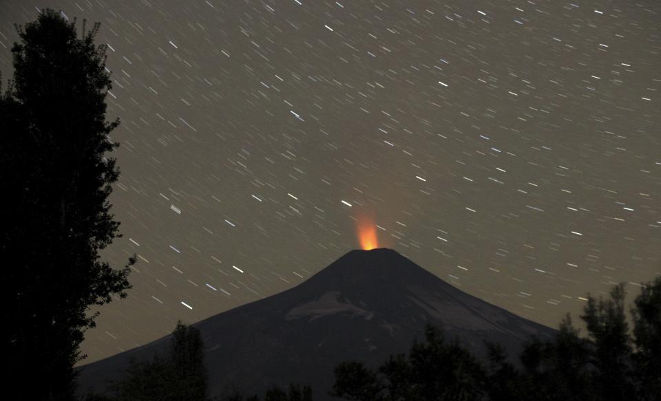 Smoke and lava spew from the Villarrica volcano, as seen from Pucon town in the south of Santiago.