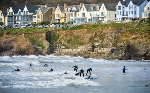 Surfers in the sea at Polzeath, Cornwall - Credit: &nbsp;Ben Birchall/&nbsp;PA
