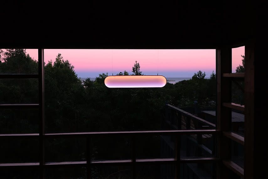 a frisbee is flying over a fence