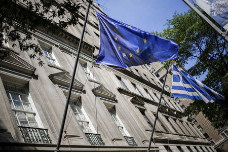 The flags of the European Union and Greece flutter at the Greece consulate in New York June 30, 2015. REUTERS/Eduardo Munoz - RTX1IHVG