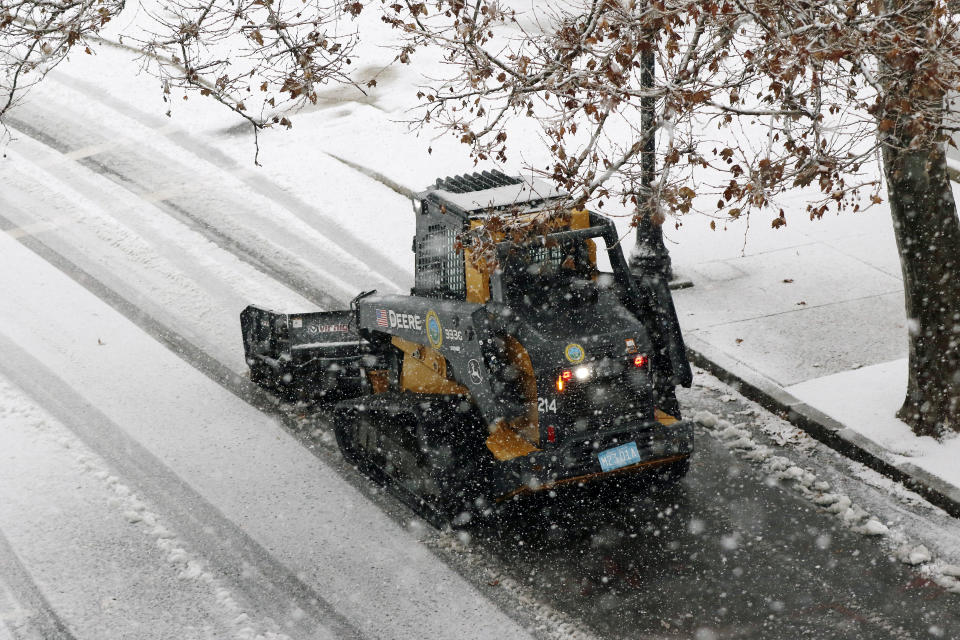 A snow clearing machine cleans a road during heavy snow, Saturday, Dec. 5, 2020, in Marlborough, Mass. The northeastern United States is seeing the first big snowstorm of the season. (AP Photo/Bill Sikes)