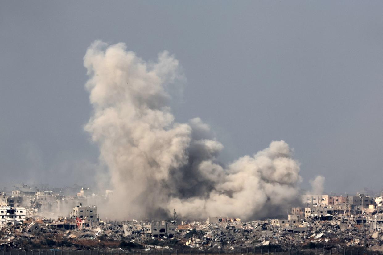 A picture taken from southern Israel near the border with the Gaza Strip on Dec. 8, 2023, shows smoke rising above buildings during an Israeli strike in northern Gaza, amid continuing battles between Israel and the militant group Hamas.