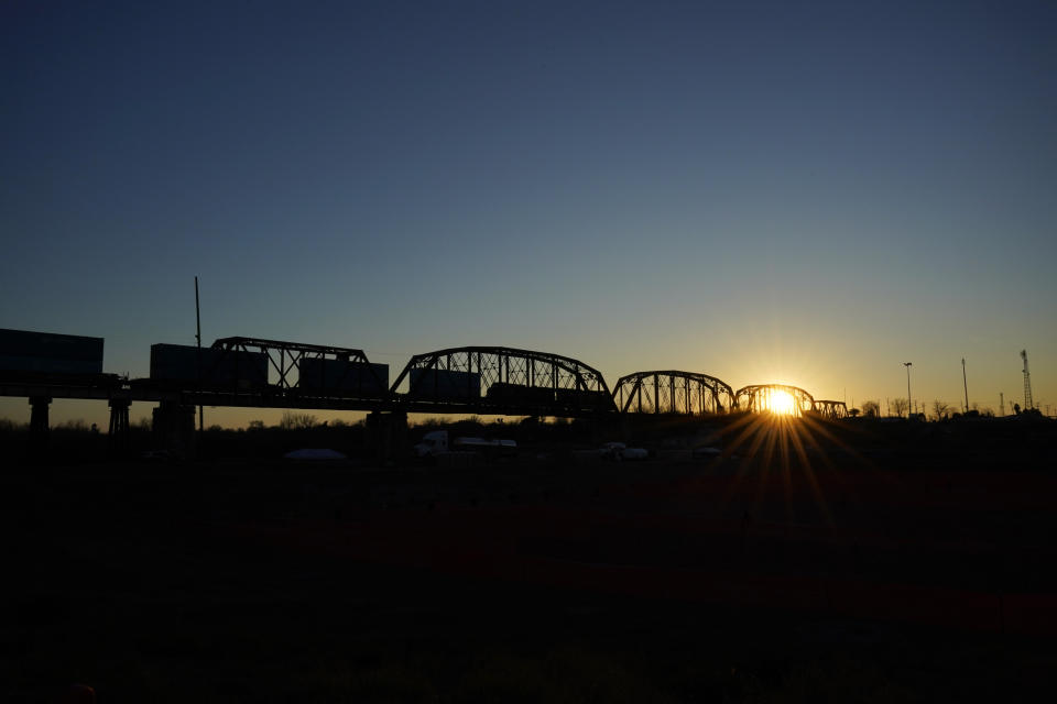 A freight train crosses the Puente Negro Ferrocarril (Black Bridge Railway) that connects Mexico and the U.S., Wednesday, Jan. 3, 2024, in Eagle Pass, Texas. According to U.S. officials, a Mexican enforcement surge, including forcing migrants off of freight trains and flying and busing migrants to the southern part of country, has contributed to a sharp drop in illegal entries to the U.S. in recent weeks. (AP Photo/Eric Gay)