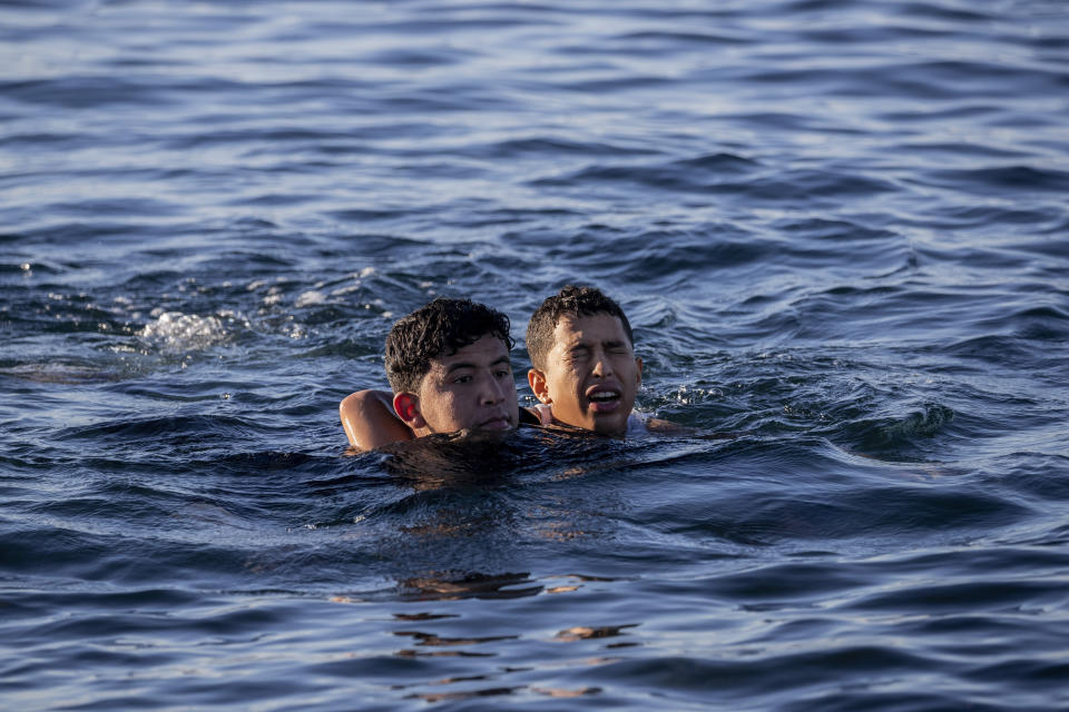 Migrants arrive at the Spanish enclave of Ceuta, near the border of Morocco and Spain, Wednesday, May 19, 2021. Spanish officials are acknowledging for the first time that the unprecedented migrant crisis has been triggered by an angry Rabat at Madrid's decision to provide medical treatment to the militant boss of the Polisario Front. (AP Photo/Bernat Armangue)