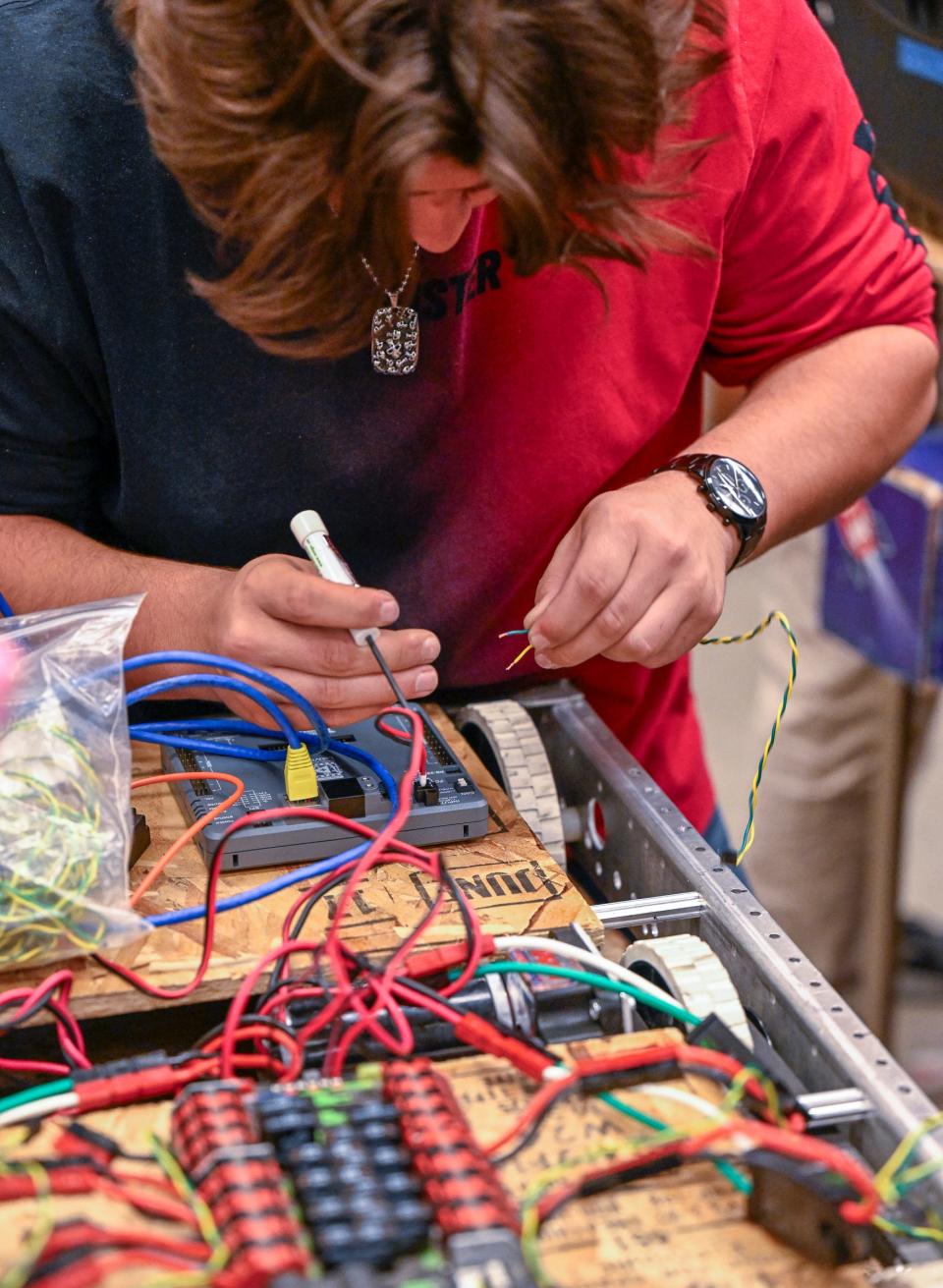 Redwood student Jace Ortiz works after school with University Preparatory High School students on a robotics project Wednesday, November 15, 2023. Redwood High School’s Robotics team will compete in the Central Valley Regional at the Fresno Fairgrounds thanks to a $6,000 NASA grant.