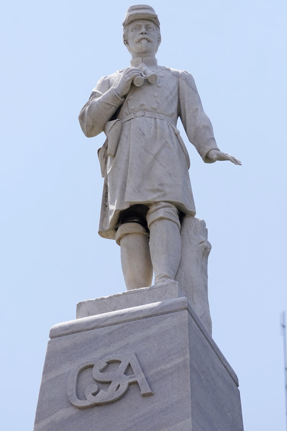 A figure of a Confederate officer, erected in 1913 in Greenwood, Miss., by the Varina Jefferson Davis Chapter of the United Daughters of the Confederacy, in Greenwood, Miss., sits on the lawn of the Leflore County Courthouse, July 14, 2021. For more than a century, one of Mississippi’s largest and most elaborate Confederate monuments has looked out over the lawn at the courthouse in the center of Greenwood. It's a Black-majority city with a rich civil rights history. Officials voted last year to remove the statue, but little progress has been made to that end. (AP Photo/Rogelio V. Solis)