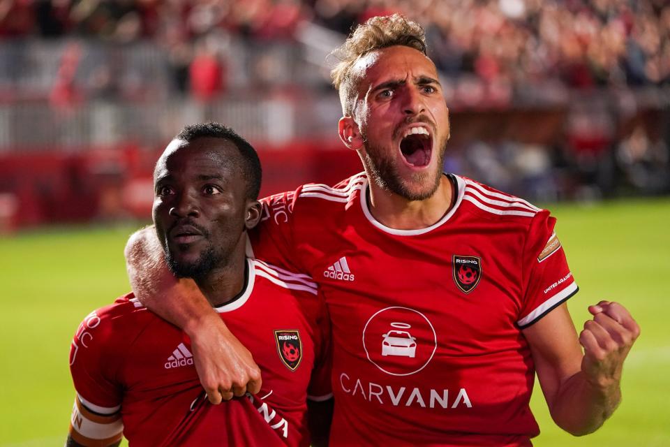 Phoenix Rising FC forward Solomon Asante (20), left, and Phoenix Rising FC defender Joe Farrell (15), right, celebrate after Asante scored to put the Phoenix 3-2 up during the second half against RGV Toros FC on Saturday, Nov. 6, 2021, at Wild Horse Pass Stadium, in Chandler.