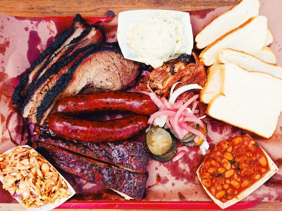 Texas Barbecue ribs, brisket, beans, and sides on a tray