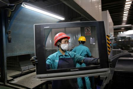 Workers dismantle used television sets at a recycling plant in Neijiang, Sichuan province, China June 11, 2018. REUTERS/Stringer/Files