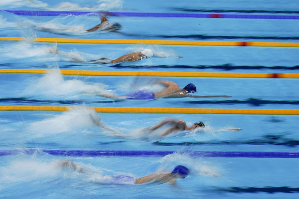 Swimmers compete in a heat of the men's 800-meter freestyle at the 2020 Summer Olympics, Tuesday, July 27, 2021, in Tokyo, Japan. (AP Photo/Charlie Riedel)