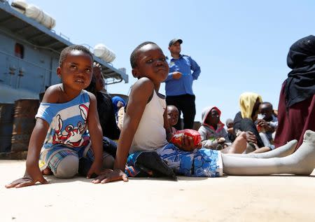 Migrants sit at a naval base after being rescued by Libyan coast guards in Tripoli, Libya June 29, 2018. REUTERS/Ismail Zitouny