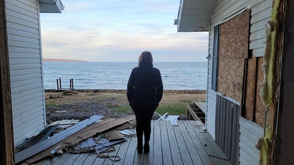 Joanne Audet looks out to sea from her house, which was slated for demolition Friday.  (Submitted by Joanne Audet - image credit)