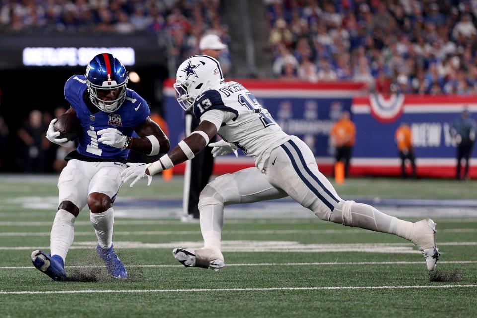 EAST RUTHERFORD, NEW JERSEY – SEPTEMBER 26: Malik Nabers #1 of the New York Giants carries the ball as DeMarvion Overshown #13 of the Dallas Cowboys attempts a tackle in the second quarter at MetLife Stadium on September 26, 2024 in East Rutherford, New Jersey. (Photo by Sarah Stier/Getty Images)