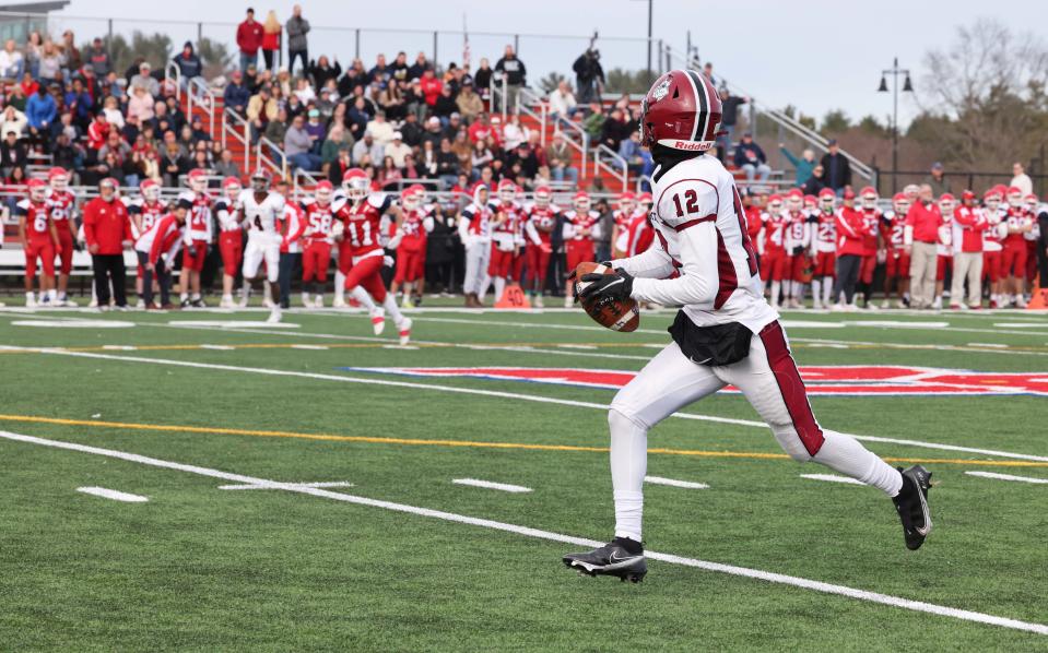 Brockton's Lucas Pires makes a touchdown pass during the Thanksgiving Day game against Bridgewater-Raynham on Thursday, Nov. 25, 2021.