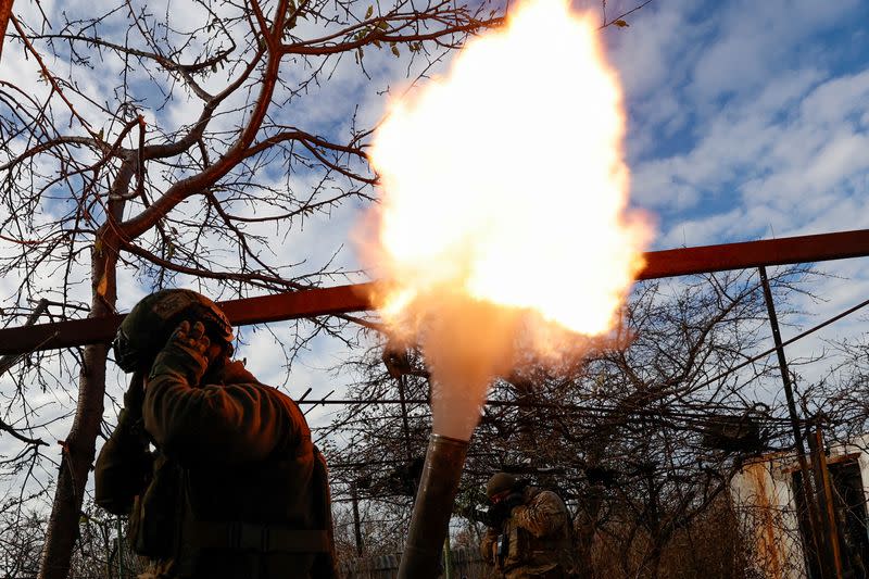 Members of Ukraine's National Guard Omega Special Purpose unit fire a mortar toward Russian troops in the front line town of Avdiivka