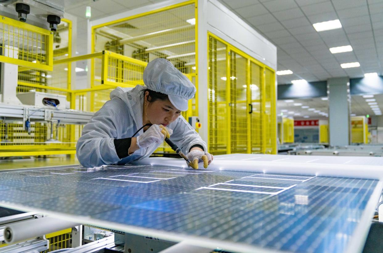 <span class="caption">China's cheaper solar panels made it harder for U.S. companies to compete.</span> <span class="attribution"><a class="link " href="https://www.gettyimages.com/detail/news-photo/an-employee-works-on-the-production-line-of-solar-panels-news-photo/1362904374" rel="nofollow noopener" target="_blank" data-ylk="slk:Ruan Xuefeng/VCG via Getty Images;elm:context_link;itc:0;sec:content-canvas">Ruan Xuefeng/VCG via Getty Images</a></span>