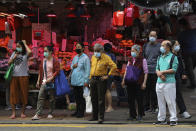 People wearing face masks to help protect themselves from contracting the coronavirus COVID-19 as they cross a street in Hong Kong, Saturday, April 18, 2020. (AP Photo/Kin Cheung)