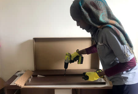 Maty Drame, an employee at odd-jobs platform Task Rabbit, assembles IKEA furniture at the apartment of customer Jessica Reznik in Washington Heights in the New York City borough of Manhattan, New York, U.S., October 21, 2018. Picture taken October 21, 2018. REUTERS/Melissa Fares