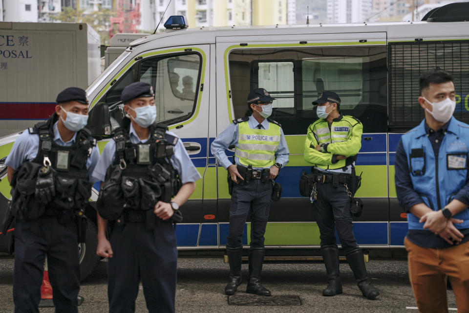 Policemen stand guard outside the West Kowloon Magistrates' Courts ahead of the national security trial for the pro-democracy activists in Hong Kong, Monday, Feb. 6, 2023. Some of Hong Kong's best-known pro-democracy activists went on trial Monday in the biggest prosecution yet under a law imposed by China's ruling Communist Party to crush dissent. (AP Photo/Anthony Kwan)