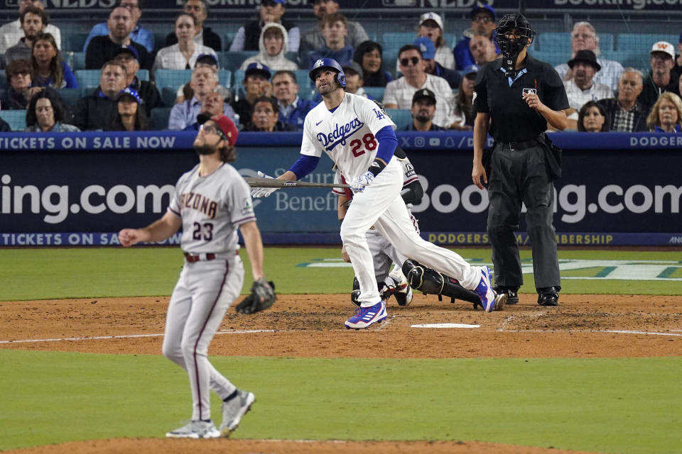 Los Angeles Dodgers' J.D. Martinez (28) watches his solo home run hit off Arizona Diamondbacks starting pitcher Zac Gallen (23) during the fourth inning in Game 2 of a baseball NL Division Series, Monday, Oct. 9, 2023, in Los Angeles. (AP Photo/Mark J. Terrill)