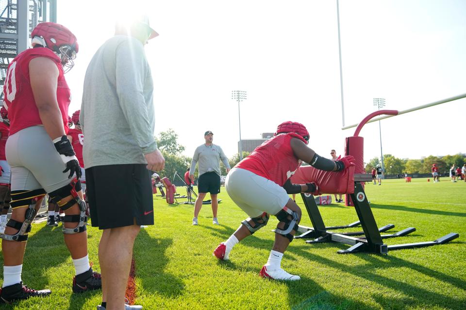 Ohio State offensive lineman Tegra Tshabola, here hitting a tackling sled during fall practice, is listed as standing 6-foot-6 and 327 pounds.