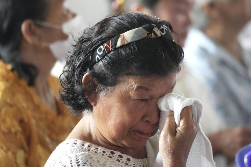 A relative of a victim cries during the Buddhist ceremony in the rural town of Uthai Sawan, in Nong Bua Lamphu province, northeastern Thailand, Friday, Oct. 6, 2023. A memorial service takes place to remember those who were killed in a grisly gun and knife attack at a childcare center. A former police officer killed 36 children and teachers in the deadliest rampage in Thailand's history one year ago. (AP Photo/Sakchai Lalit)