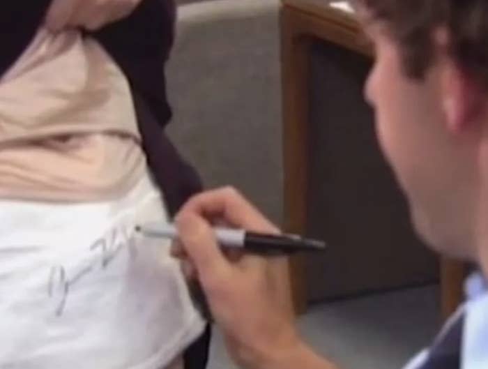 John Krasinski signing his name