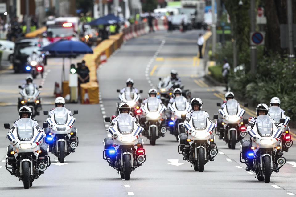 In this June 12, 2018, file photo, police officers lead a motorcade of North Korean leader Kim Jong Un as they leave the St. Regis Hotel on the way to the Capella Hotel in Singapore where the summit between Kim and U.S. President Donald Trump will take place. Trump and Kim are planning a second summit in the Vietnam capital of Hanoi, Feb. 27-28. (AP Photo/Yong Teck Lim, File)