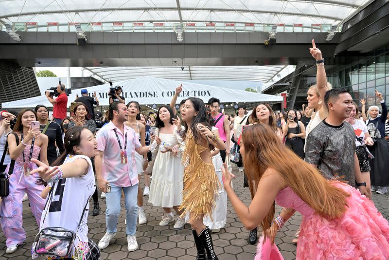 Taylor Swift fans, or Swifties, dance to her music at the National Stadium during Swift's Eras Tour concert in Singapore
