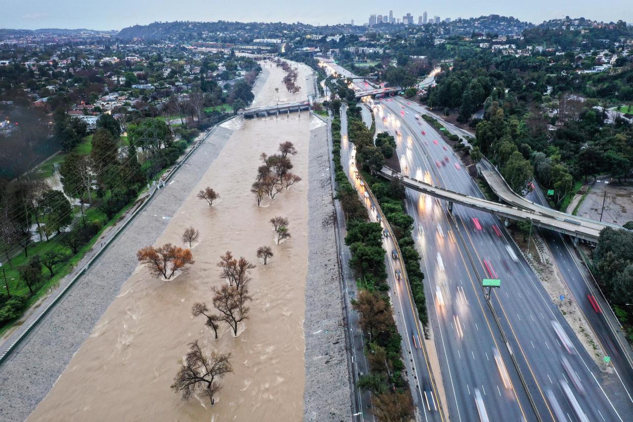 <span>The Los Angeles River is swollen by storm runoff during an atmospheric river storm on Monday.</span><span>Photograph: Mario Tama/Getty Images</span>