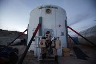 �Members of Crew 125 EuroMoonMars B mission return after collecting geologic samples for study at the Mars Desert Research Station (MDRS) in the Utah desert March 2, 2013. The MDRS aims to investigate the feasibility of a human exploration of Mars and uses the Utah desert's Mars-like terrain to simulate working conditions on the red planet. Scientists, students and enthusiasts work together developing field tactics and studying the terrain. All outdoor exploration is done wearing simulated spacesuits and carrying air supply packs and crews live together in a small communication base with limited amounts of electricity, food, oxygen and water. Everything needed to survive must be produced, fixed and replaced on site. Picture taken March 2, 2013. REUTERS/Jim Urquhart