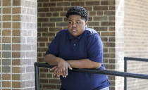 In this Sept. 26, 2021, photo Royal Smart poses for a portrait in a Chicago park. Smart still has nightmares about being handcuffed for nearly 30 minutes when he was 8 years old, alongside his mother and other adults. Neither he nor anyone else was arrested at his family's home on Chicago's South Side when police wielding a warrant came looking for illegal weapons and found none. (AP Photo/Teresa Crawford)