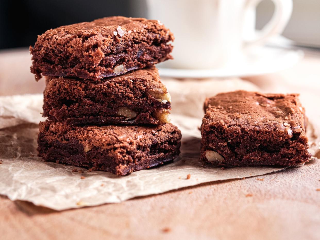 Coffe cup and brownies on table