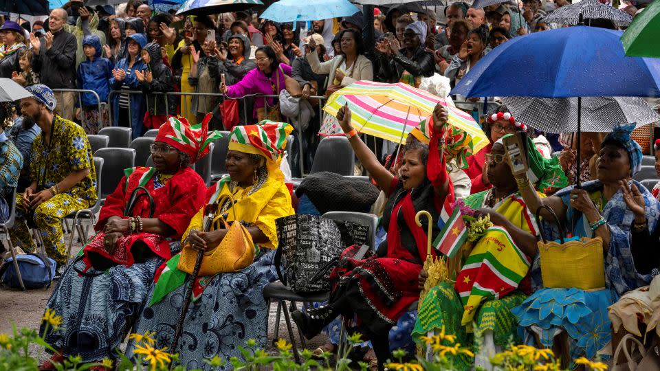 Spectators react after King Willem-Alexander apologized for the royal house's role in slavery at an event to commemorate the anniversary of the abolition of slavery by the Netherlands on Saturday. - Peter Dejong/Pool/Reuters