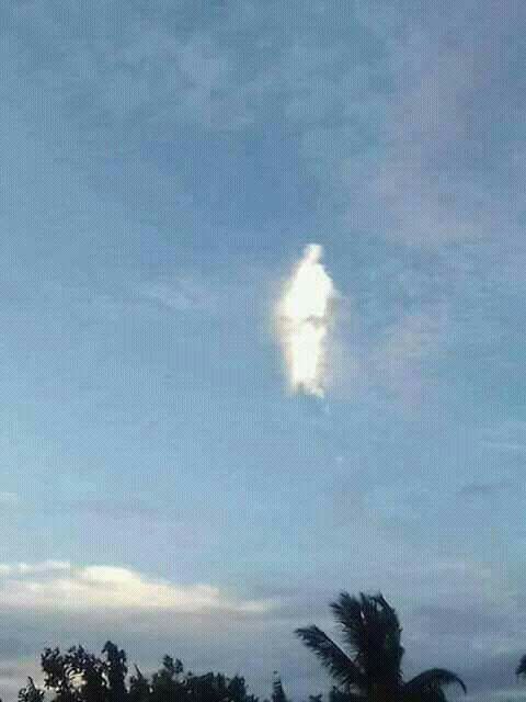 The surrounding clouds disappeared and the sun lit up the figure. Photo: Supplied/Facebook