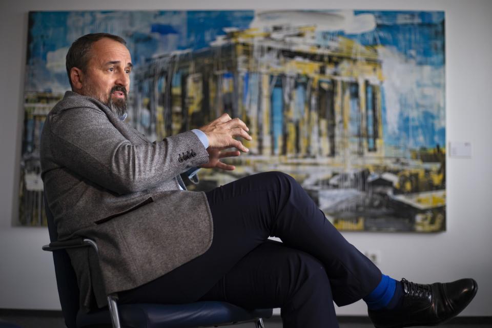 In this photo taken on Thursday, March 21, 2019, Dmitry Aksenov, property developer and art collector gestures while speaking during an interview with The Associated Press in Moscow, Russia. A physicist by training, Aksenov took a scientific approach once he decided to collect art and set about studying cultural history to train his eye. (AP Photo/Alexander Zemlianichenko Jr.)