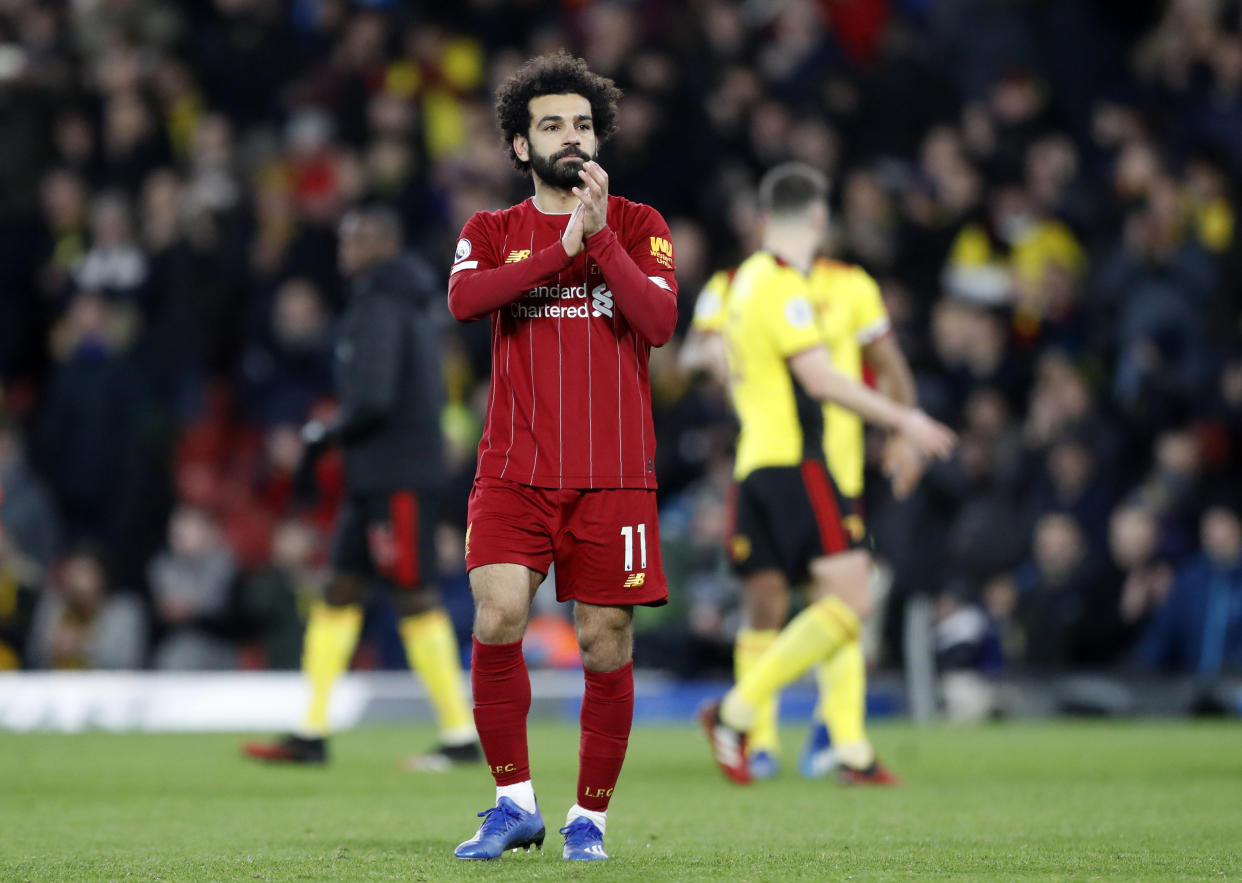 Liverpool's Mohamed Salah applauds to supporters and leaves the field at the end of the English Premier League soccer match between Watford and Liverpool at Vicarage Road stadium, in Watford, England, Saturday, Feb. 29, 2020. The match finished 3-0. (AP Photo/Alastair Grant)