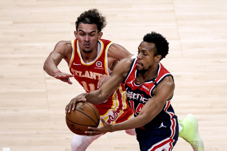 Atlanta Hawks guard Trae Young (11) tries to steal the ball from Washington Wizards guard Ish Smith (14) as they come down court during the second half of an NBA basketball game Wednesday, May 12, 2021, in Atlanta. Atlanta Hawks defeated the Washington Wizards 120-116. (AP Photo/Butch Dill)