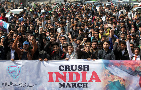 FILE PHOTO: Supporters of Jamiat Talaba Islam (JTI), student wing of religious and political party Jamaat-e-Islami (JI), chant slogans as they celebrate, after Pakistan shot down two Indian military aircrafts, in Lahore, Pakistan February 27, 2019. REUTERS/Mohsin Raza/File Photo