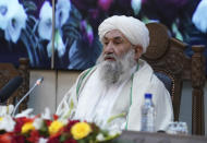 CORRECTS SPELLING OF PRIME MINISTER FROM HASSAN TO HASAN -- Taliban Prime Minister Mohammad Hasan Akhund speaks during an economic conference at the former Presidential Palace in Kabul, Afghanistan, Wednesday, Jan. 19, 2022. Even as Afghanistan faces a humanitarian catastrophe and its economy teeters on the brink of collapse, the United Nations representative on Wednesday told a Taliban-organized economic conference in the capital Kabul there have been some advances, including a surprising $1 billion in exports. (Taliban Prime Minister Media Office via AP)