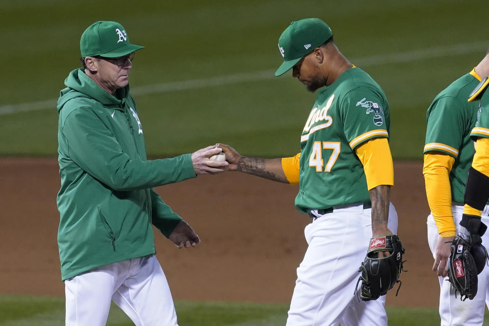 Oakland Athletics pitcher Frankie Montas (47) hands the ball to manager Bob Melvin as he is taken out for a relief pitcher during the seventh inning of a baseball game against the Kansas City Royals in Oakland, Calif., Thursday, June 10, 2021. (AP Photo/Jeff Chiu)