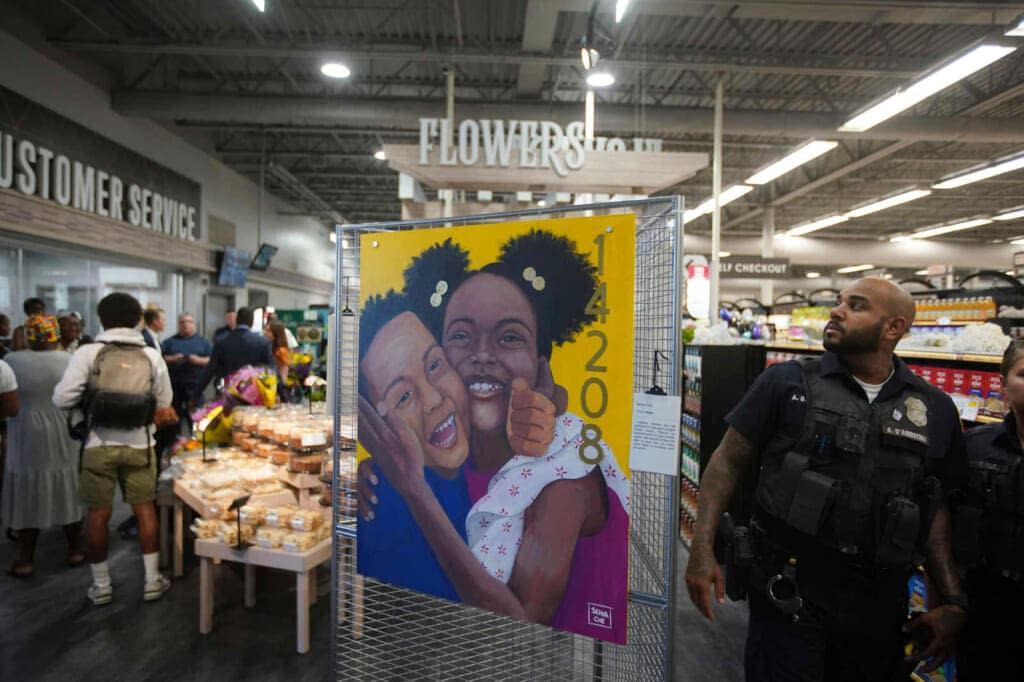 A painting titled “Hope” by Senia Che is on display as dignitaries and members of the media take a tour of the newly renovated Tops Friendly Markets on Jefferson Avenue in Buffalo, N.Y., which reopens tomorrow, two months after the racist attack, Thursday, July 14, 2022. (Derek Gee/The Buffalo News via AP)