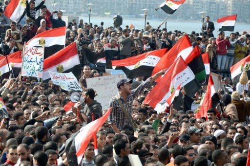 Egyptian protestors wave national flags and shout anti-government slogans during mass rally in the northern Mediterranean port of Alexandria in 2011 as protests continued in Egypt to demand the end of military rule. Egypt's ousted president Hosni Mubarak, now serving a life sentence over protester killings, said the authorities "want to kill" him in jail as his health deteriorated