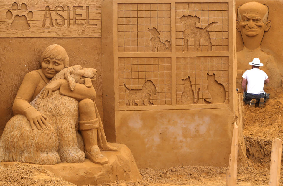 A sand carver works on a sculpture during the Sand Sculpture Festival "Dreams" in Ostend, Belgium June 18, 2019. (Photo: Yves Herman/Reuters)