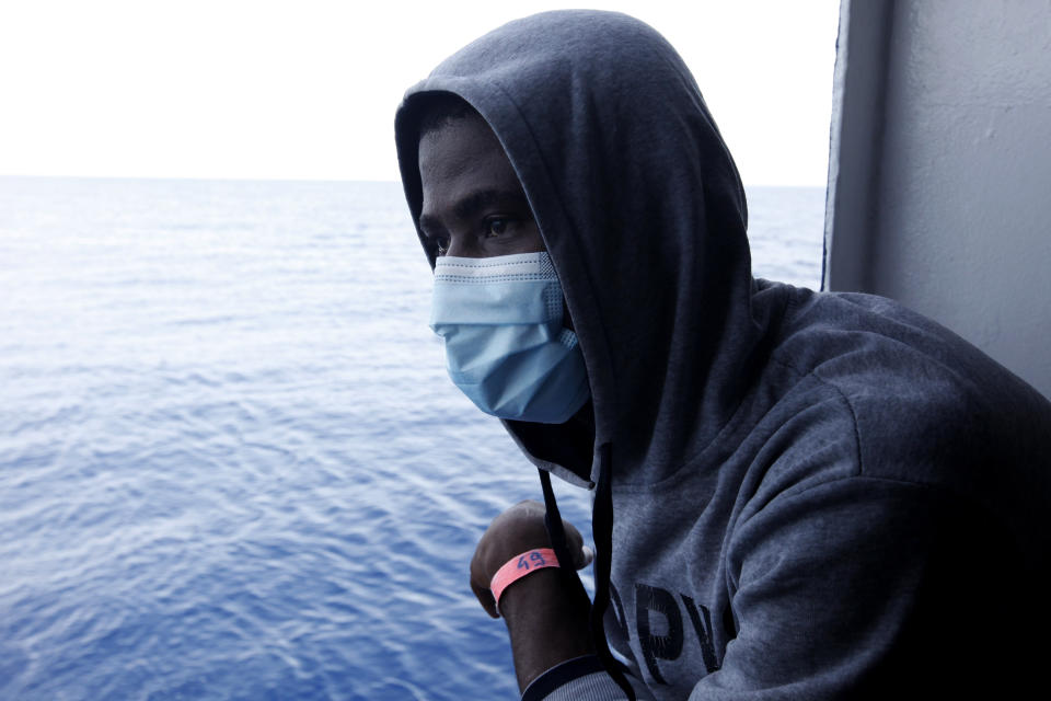 Guinean migrant Amadou Traoré looks at the Mediterranean as he awaits disembarkation at the port of Augusta, on the island of Sicily, Italy, Monday, Sept. 27, 2021. Traoré and other migrants say they were tortured and their families extorted for ransoms in Libya’s detention centers. Their accounts to The Associated Press come as a report commissioned by the United Nations said last week that suspected crimes against humanity have been committed against migrants intercepted at sea and turned over to Libya’s detention centers. (AP Photo/Ahmed Hatem)