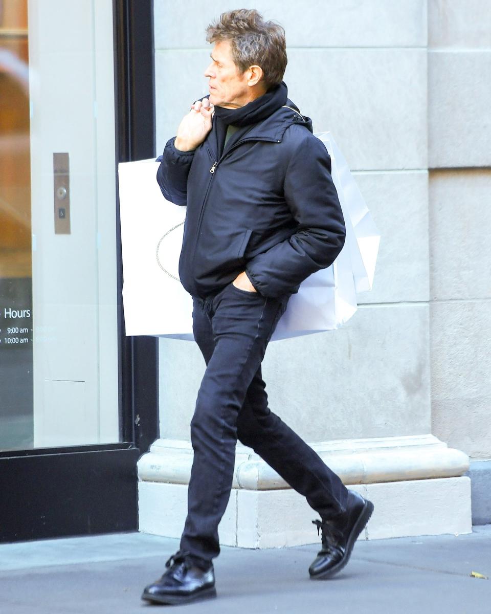 Willem Dafoe carries home two bags' worth of more #BigFitoftheDay ammo from Prada.