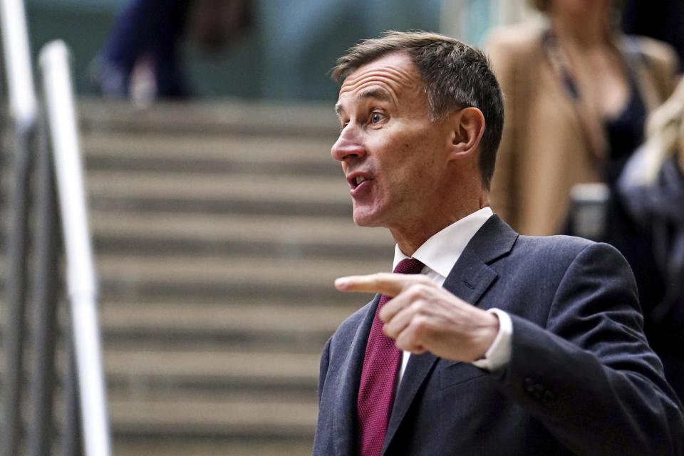 British Chancellor Jeremy Hunt gestures before speaking to the media at Victoria Place Shopping Centre, Woking, in response to the Bank of England Monetary Policy Report, Thursday Feb. 2, 2023. PA Photo. (Jordan Pettitt/PA via AP)