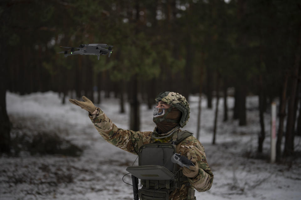 A Ukrainian serviceman lands a drone during a demonstration close to the border with Belarus, Ukraine, Wednesday, Feb. 1, 2023. Reconnaissance drones fly several times a day from Ukrainian positions across the border into Belarus, a close Russian ally, scouring for signs of trouble on the other side. Ukrainian units are monitoring the 1,000-kilometer (650-mile) frontier of marsh and woodland for a possible surprise offensive from the north, a repeat of the unsuccessful Russian thrust towards Kyiv at the start of the war nearly a year ago. (AP Photo/Daniel Cole)