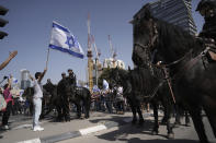Mounted police are deployed as Israelis block a main road to protest against plans by Prime Minister Benjamin Netanyahu's new government to overhaul the judicial system, in Tel Aviv, Israel, Wednesday, March 1, 2023. (AP Photo/Oded Balilty)